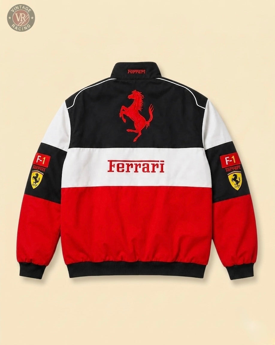 The F1 Ferrari Vintage Racing Jacket - Black, White & Red Edition features bold Ferrari text, a large prancing horse logo on the back, and Ferrari shield F1 patches on each sleeve.