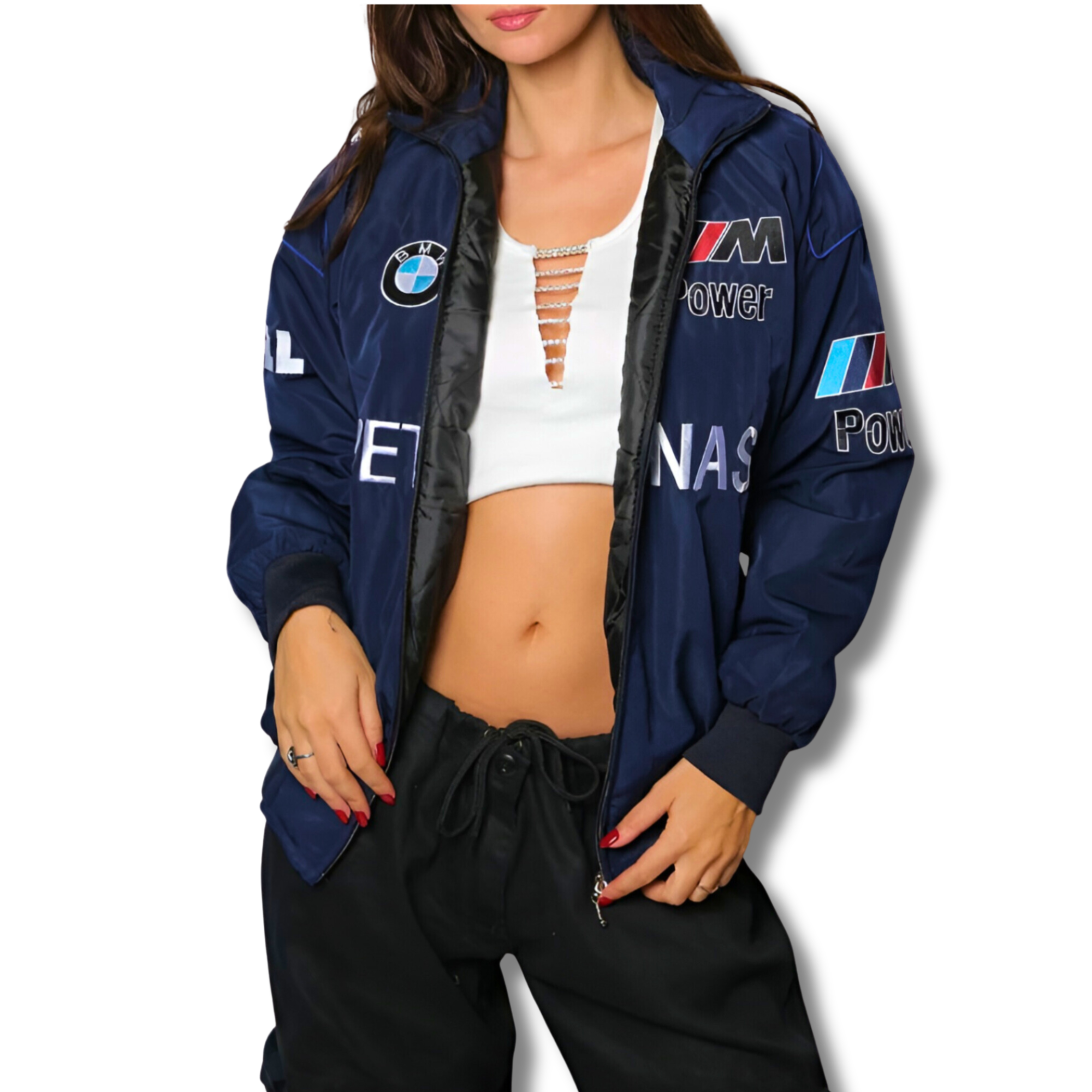 Someone stands against a white background, wearing the BMW F1 Vintage Racing Jacket - Classic Edition over a white crop top and black pants.