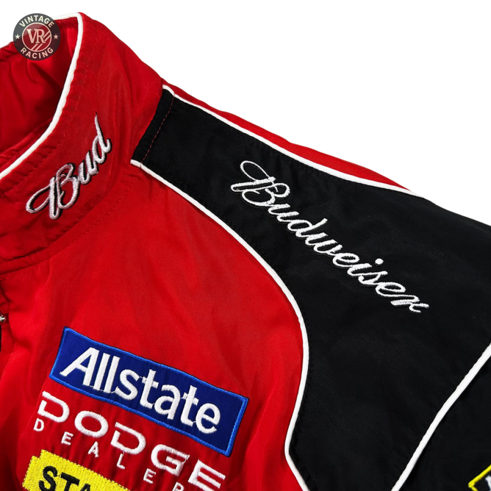 The Budweiser Racing Vintage Jacket - NASCAR Red Edition showcases embroidered Bud and Budweiser logos, with Allstate and Dodge Dealers patches—capturing classic vintage motorsport jacket style.