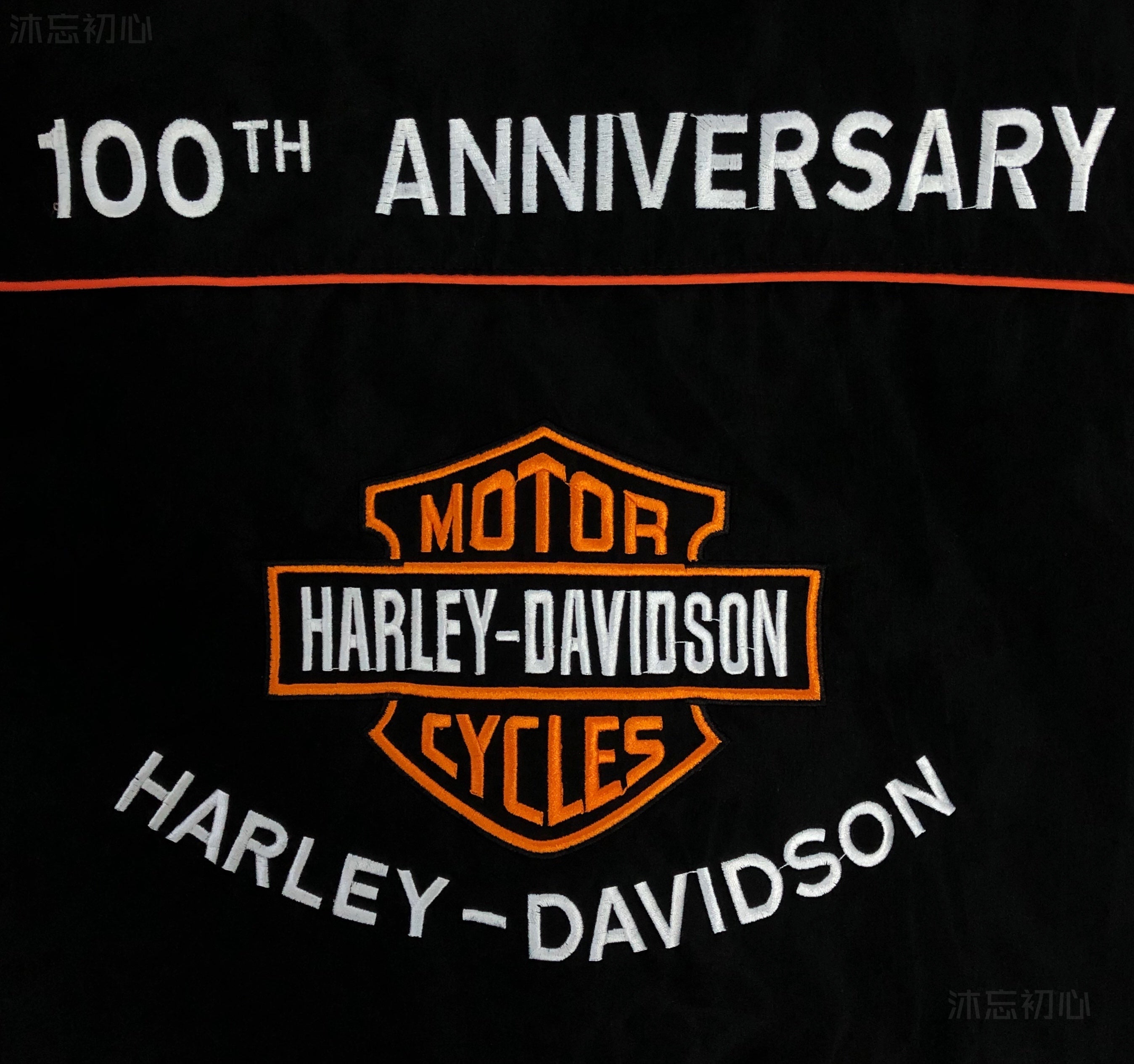Embroidered Harley-Davidson logo with 100th Anniversary text in white and orange on black—ideal for any Vintage Harley Davidson Jacket.