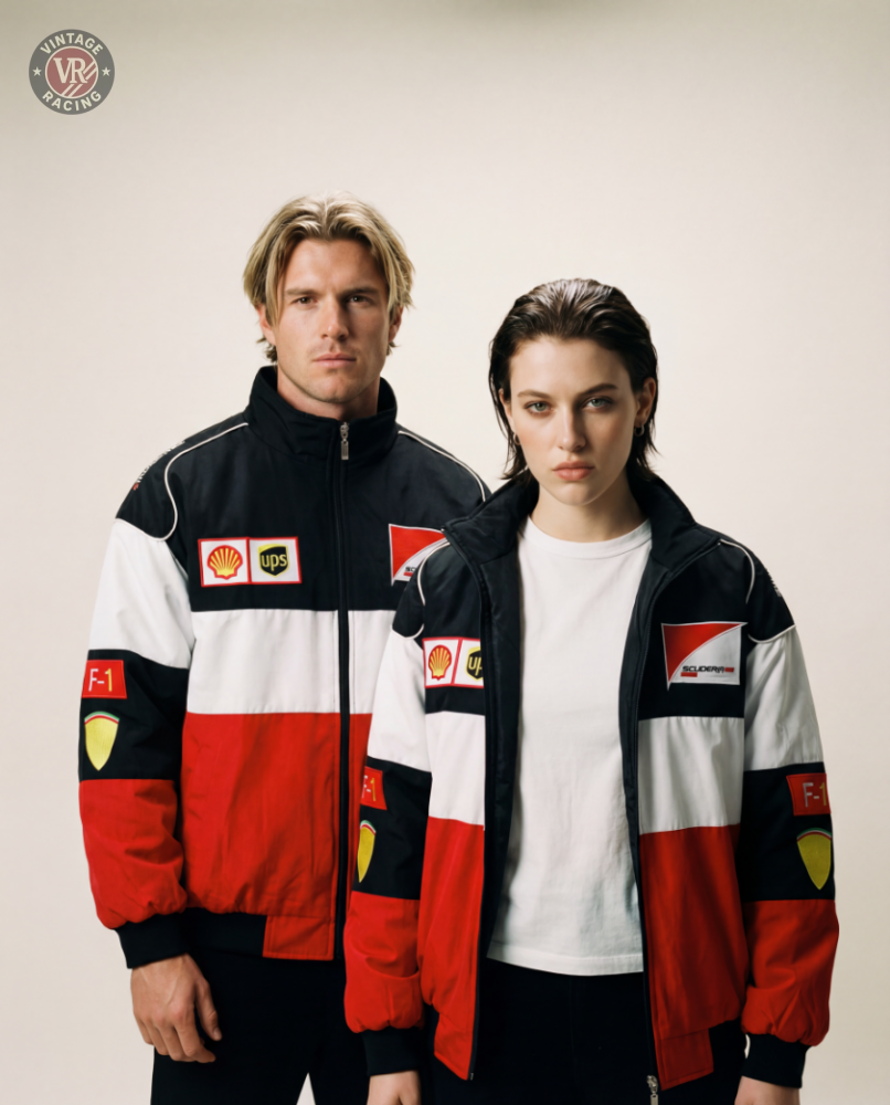 A man and a woman pose together against a plain, light background, both wearing matching F1 Vintage Racing Jacket - Classic Edition with red, white, and black color blocks and authentic sponsor patches.