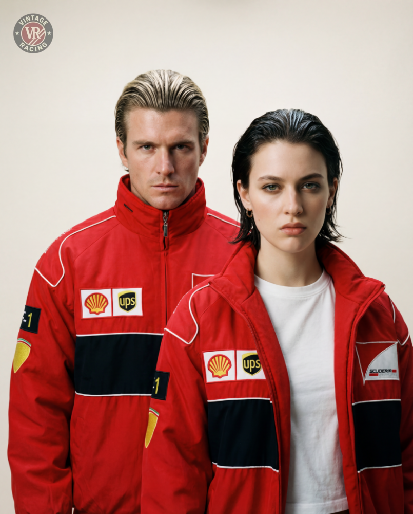 A man and a woman stand side by side in matching F1 Vintage Racing Jacket - Red Edition with Shell and UPS logos, channeling the classic spirit of vintage F1 style against a plain light background.