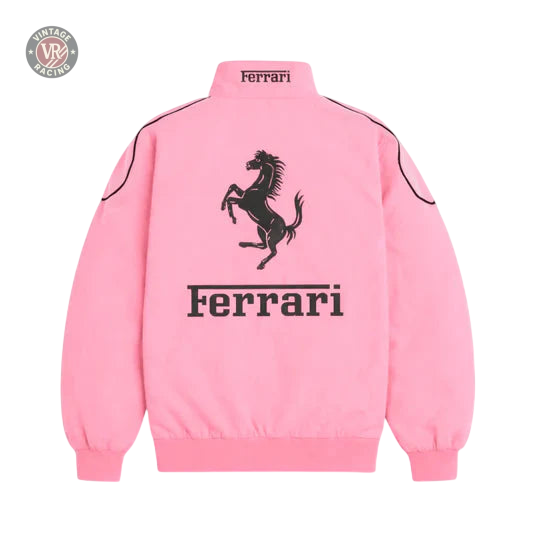 The Ferrari F1 Vintage Racing Jacket - Pink Edition features a black prancing horse logo, “Ferrari” on the back, a high collar with a small Ferrari label, and long sleeves.