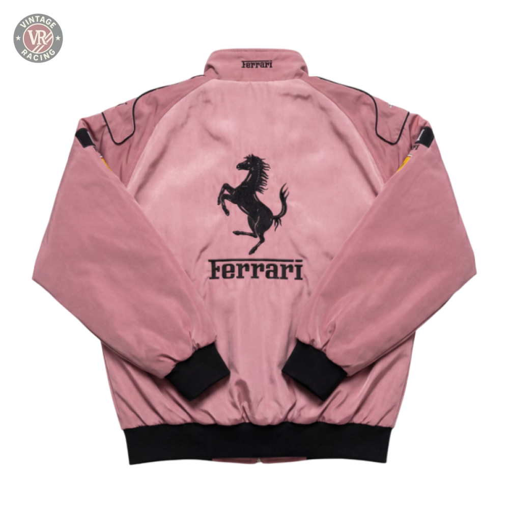 The Ferrari F1 Vintage Racing Jacket - Rose Edition features a pink design with black cuffs, waistband, and collar, plus subtle black shoulder details. The back displays a large black prancing horse logo and bold Ferrari text.