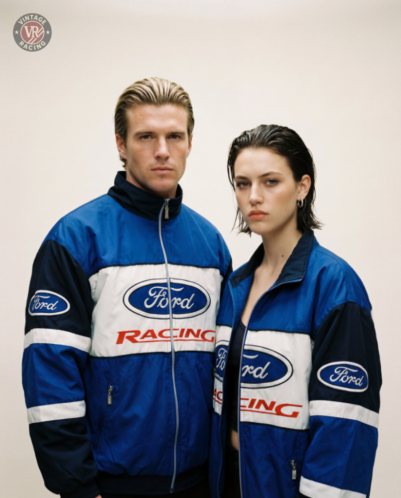 A man and woman stand side by side in matching Ford Vintage Jacket - Racing Edition, looking seriously at the camera against a plain background, embodying true muscle car heritage.