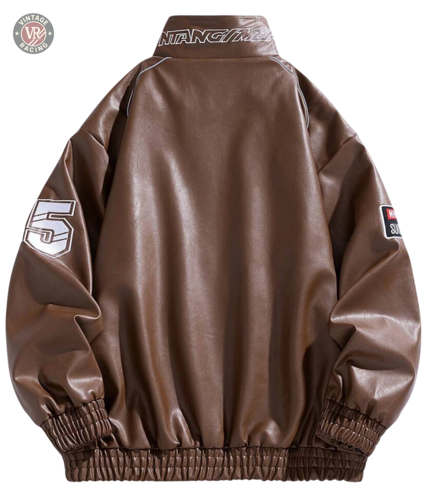 The LAP 85 Brown Racing Jacket channels an 80s driver vibe with a back view, elastic cuffs and waistband, white 5 on one sleeve, text patch on the other, and MUSTANG across the collar—a true vintage motorsport look.