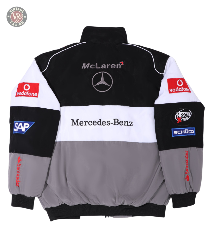 The McLaren F1 x Mercedes-Benz Vintage Jacket sports McLaren and Mercedes-Benz logos on the back, plus Vodafone, SAP, Santander, and Schüco sponsor patches on sleeves and shoulders. Available in classic black, white, and gray.