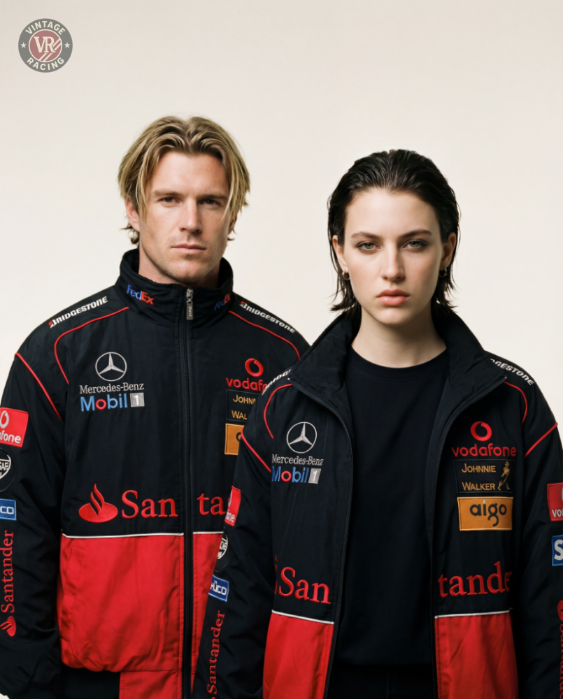 Two people in McLaren x Mercedes-Benz Vintage Jackets featuring sponsor logos stand side by side against a plain background, embodying classic Formula 1 streetwear style with serious expressions.