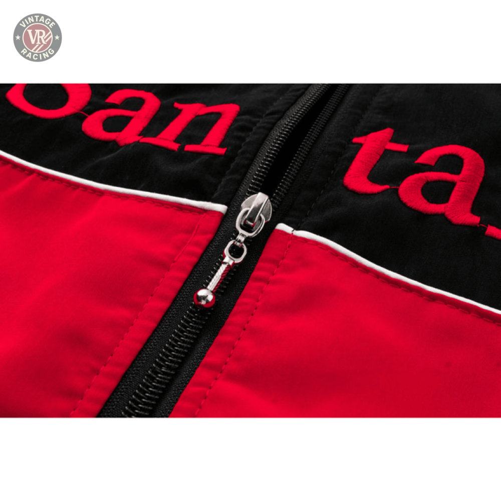 Close-up of the McLaren x Mercedes-Benz Vintage Jacket, showing its black and red color block design, black zipper, white piping, and partial red embroidered letters on the black section.