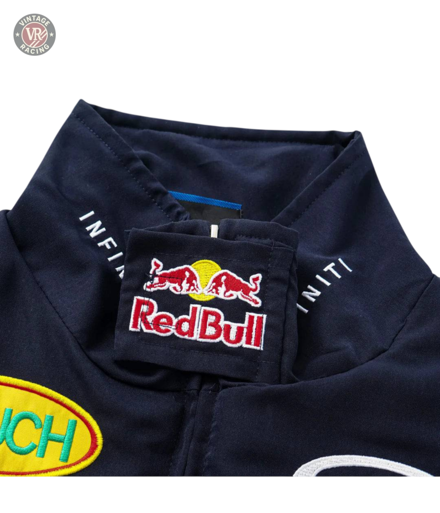 Close-up of the collar on a navy Red Bull Racing F1 Jacket, showing the bold Red Bull logo patch, Infiniti text, and part of a yellow patch—an ideal addition to any Formula 1 fans apparel collection.