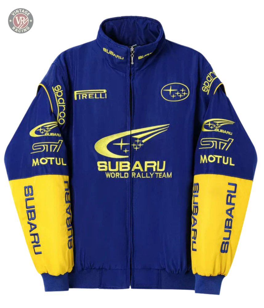 The Subaru World Rally Team Vintage Jacket features blue and yellow 555 livery, Motul, Pirelli, and Sparco sponsor logos on the chest, sleeves, and collar. Finished with a front zipper and ribbed cuffs for an authentic rally look.