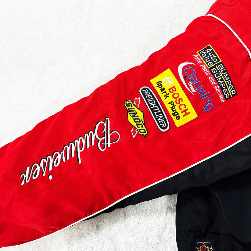 A Budweiser Vintage Racing Jacket - NASCAR Black Edition sleeve in red and black, featuring white Budweiser text and sponsor patches (Bosch, Freightliner, Snap-on), shown on a white background—ideal for vintage racing jacket collectors.