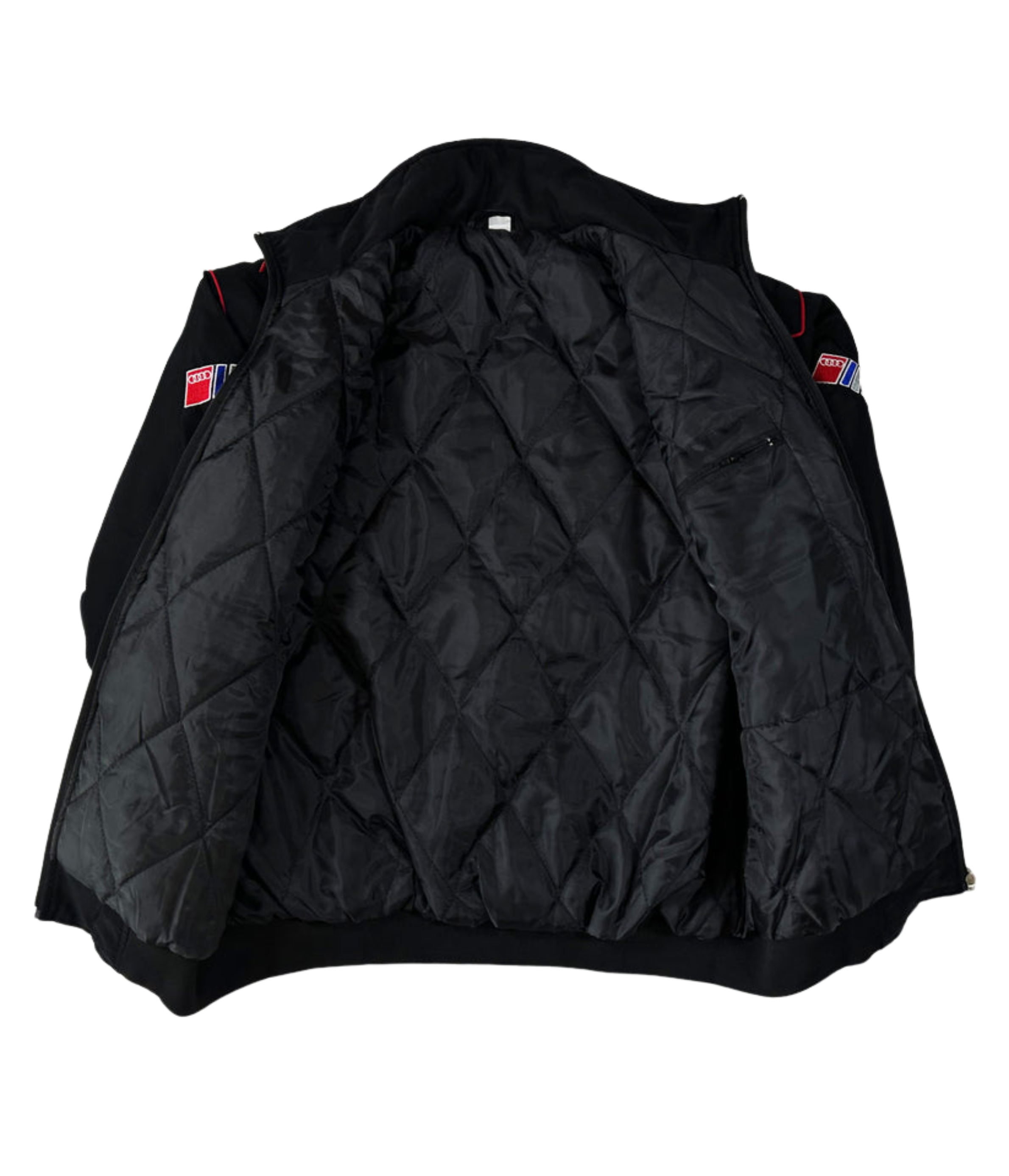 The Audi Vintage Racing Jacket is black with red and blue sleeve patches, features a quilted inner lining, and has a small zippered pocket on the left side—capturing classic vintage motorsport style.