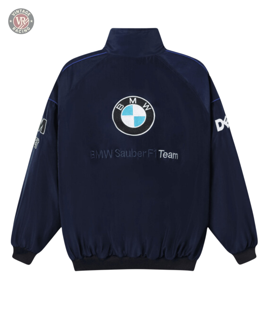 The BMW F1 Vintage Racing Jacket - Classic Edition in navy blue features the iconic BMW logo on the back, embroidered text, and white sleeve logos—a must-have vintage piece for any Formula 1 enthusiast.