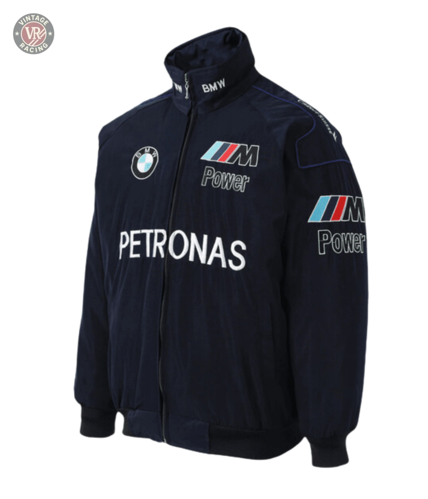 The BMW F1 Vintage Racing Jacket - Classic Edition is a navy blue jacket featuring embroidered BMW, M Power, and Petronas logos, with zip closure, stand collar, elastic cuffs and hem—a must-have for motorsport fans.