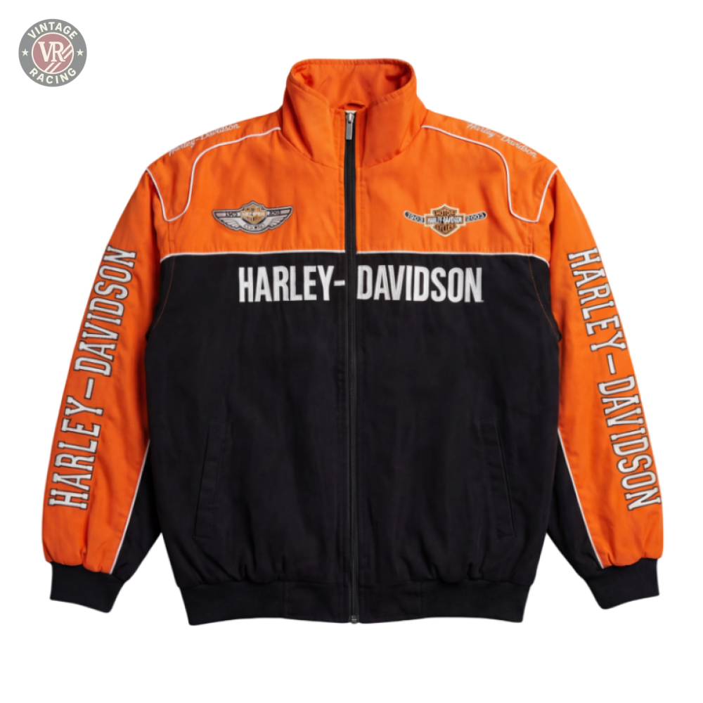 The Harley Davidson Vintage Racing Motorcycle Jacket features orange upper and black lower sections, white Harley-Davidson text on the chest and sleeves, branded patches, and a front zipper.
