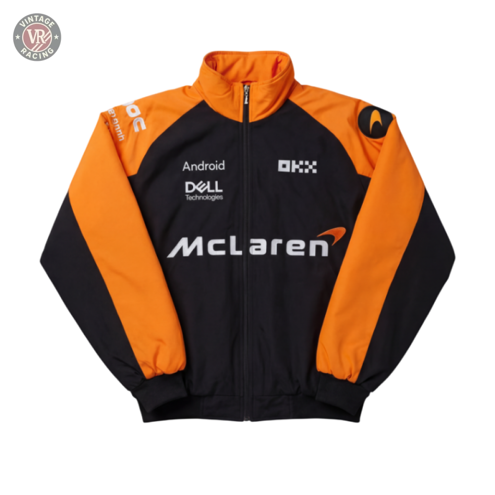 A McLaren F1 Vintage Racing Jacket in black and orange with Android, Dell Technologies, and OKX sponsor logos on the front and sleeves, laid flat on a gray background.
