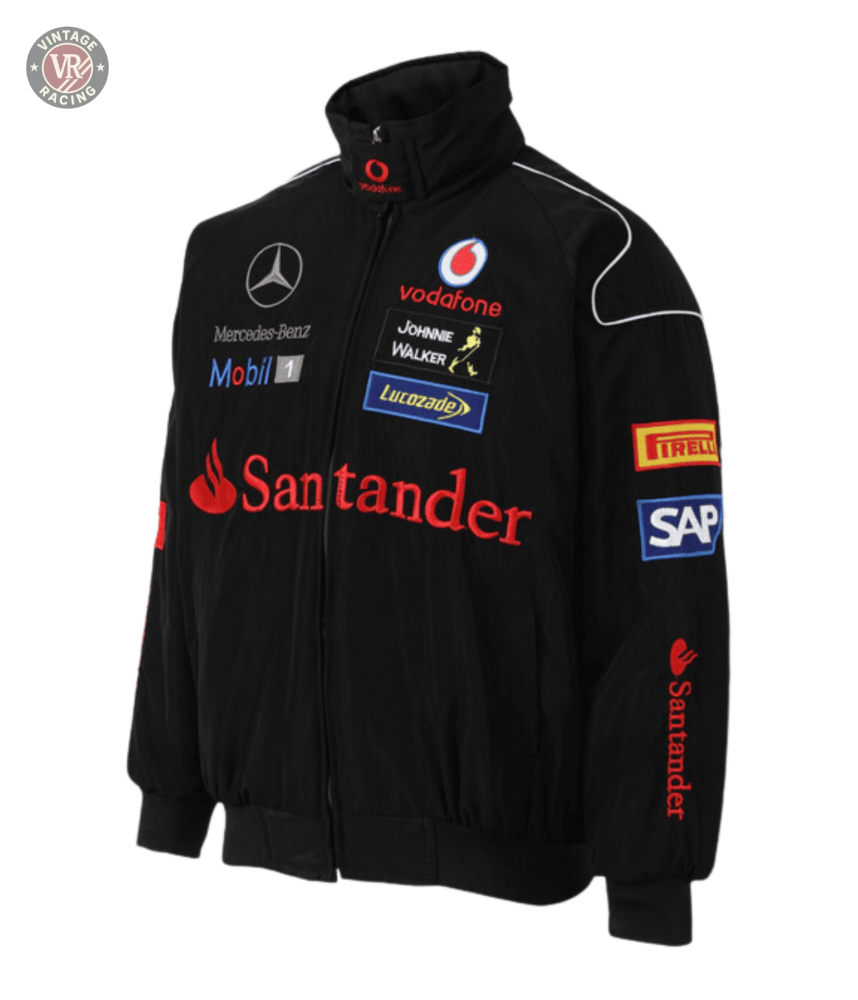 The Mercedes-Benz Santander Vintage Jacket in black features red and white accents with Vodafone, Santander, Mobil 1, SAP, Pirelli, Johnnie Walker, and Lucozade logos in stealth racing style against a white background.