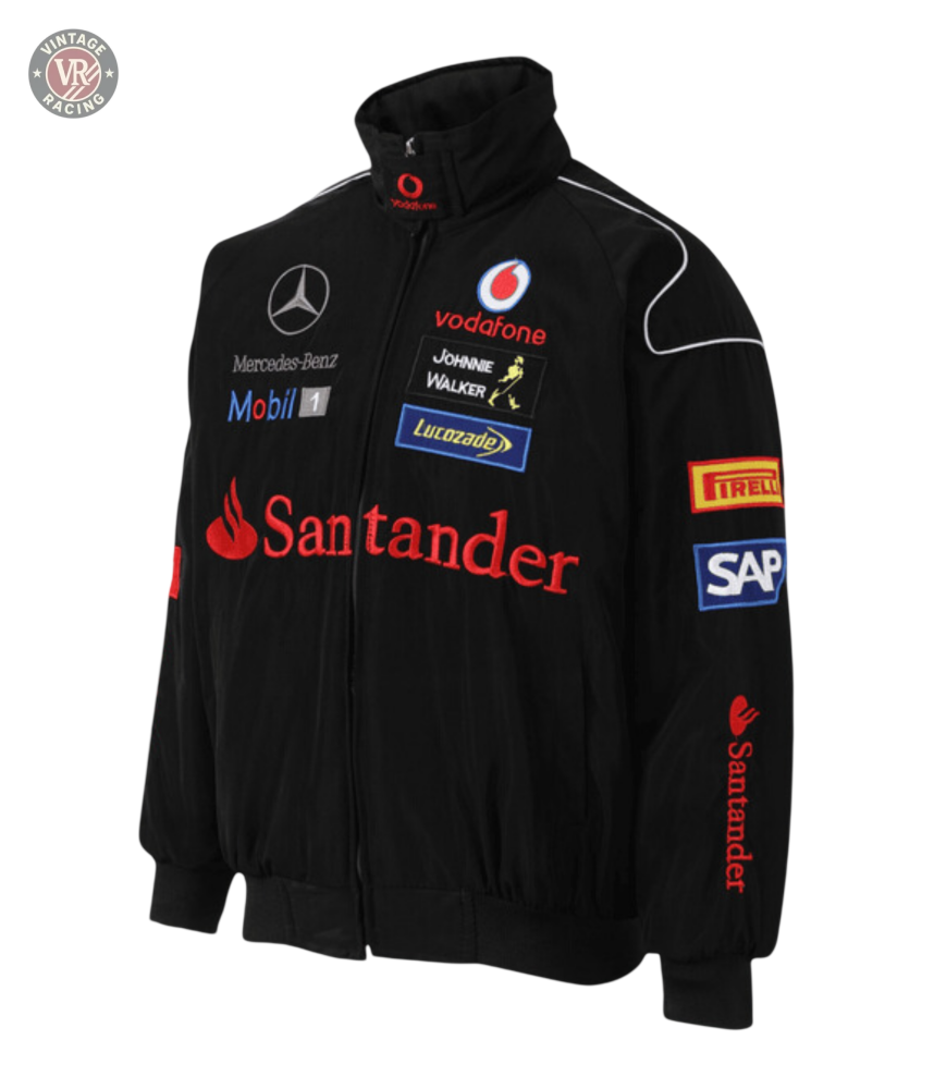 The Mercedes-Benz Santander Vintage Jacket in black features red and white accents with Vodafone, Santander, Mobil 1, SAP, Pirelli, Johnnie Walker, and Lucozade logos in stealth racing style against a white background.