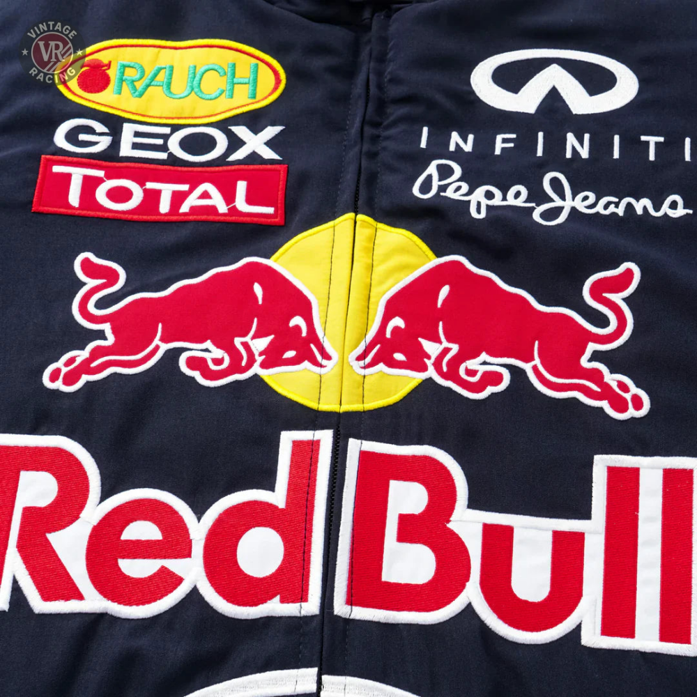 Close-up of the Red Bull Racing F1 Jacket showcasing bold Red Bull, Infiniti, Total, Geox, Rauch, and Pepe Jeans logos on dark fabric—an ideal piece for any F1 fan’s apparel collection.