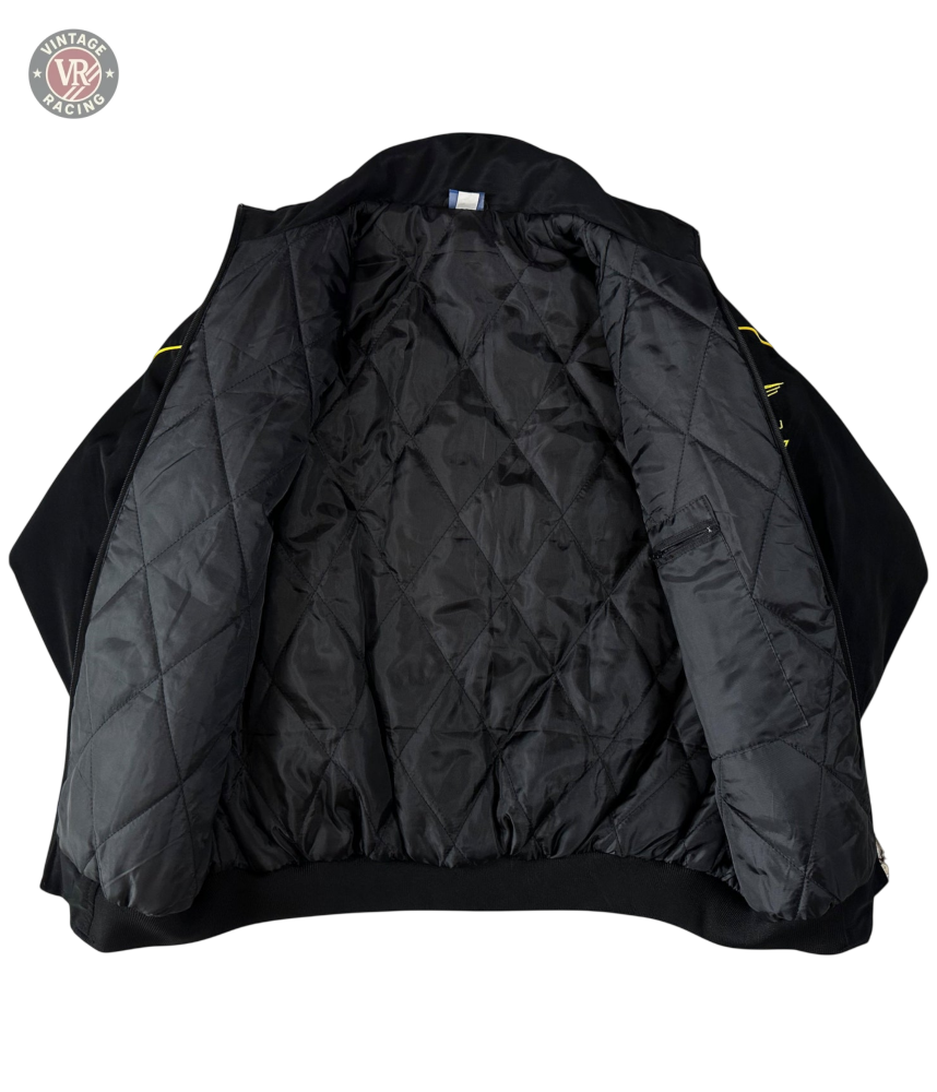 The Subaru Rally Vintage Racing Jacket is displayed open on a white background, showcasing its quilted diamond-pattern lining and classic rally heritage style.