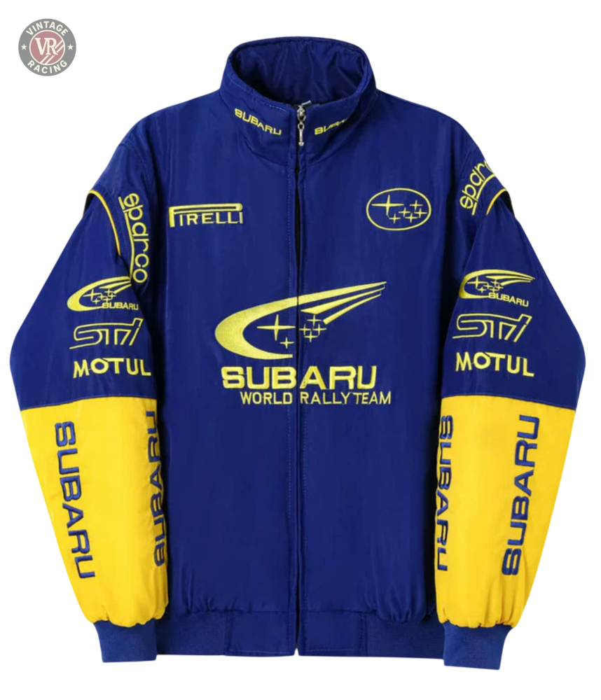 The Subaru World Rally Team Vintage Jacket features blue and yellow 555 livery, Motul, Pirelli, and Sparco sponsor logos on the chest, sleeves, and collar. Finished with a front zipper and ribbed cuffs for an authentic rally look.