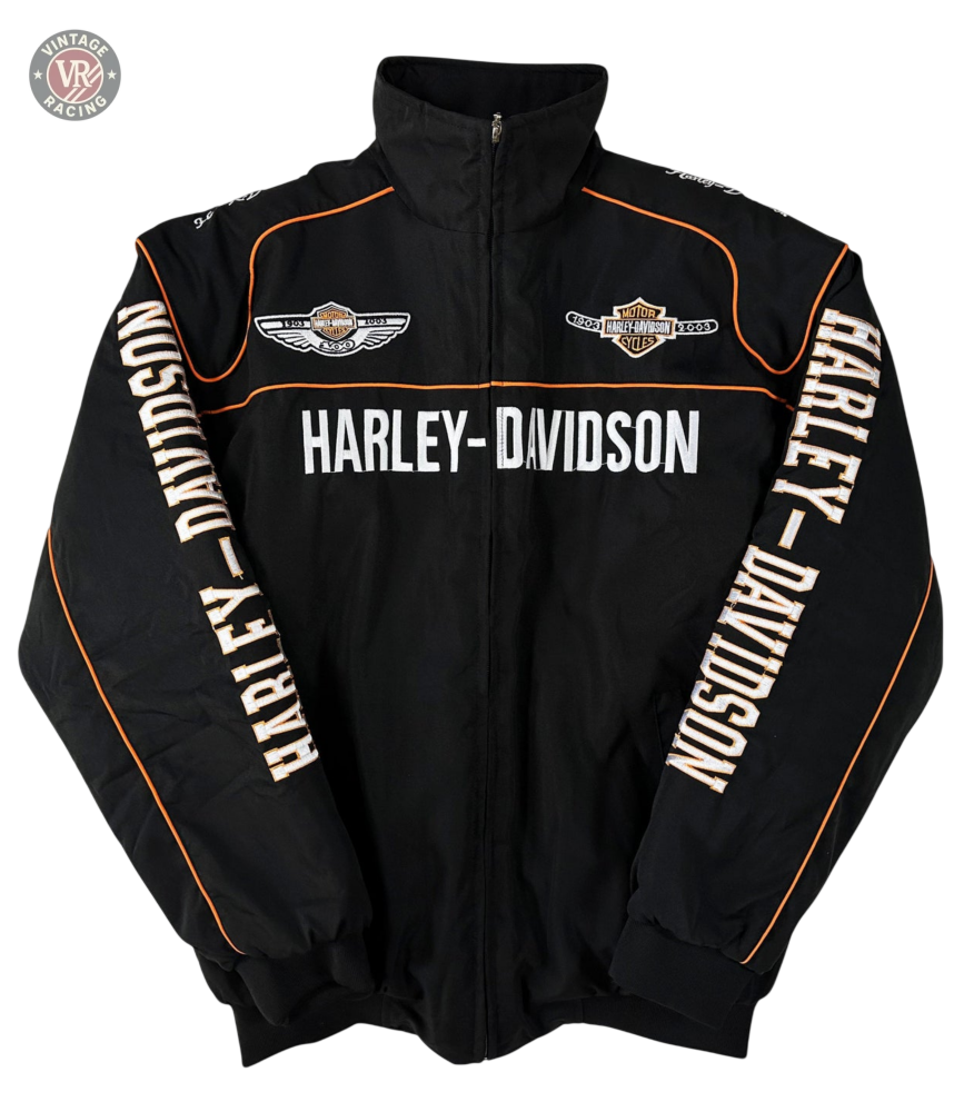The Vintage Harley Davidson Jacket is black with orange piping and embroidered logos, featuring HARLEY-DAVIDSON across the chest and sleeves. This retro motorcycle jacket has a zip-up front and high collar for classic biker style.