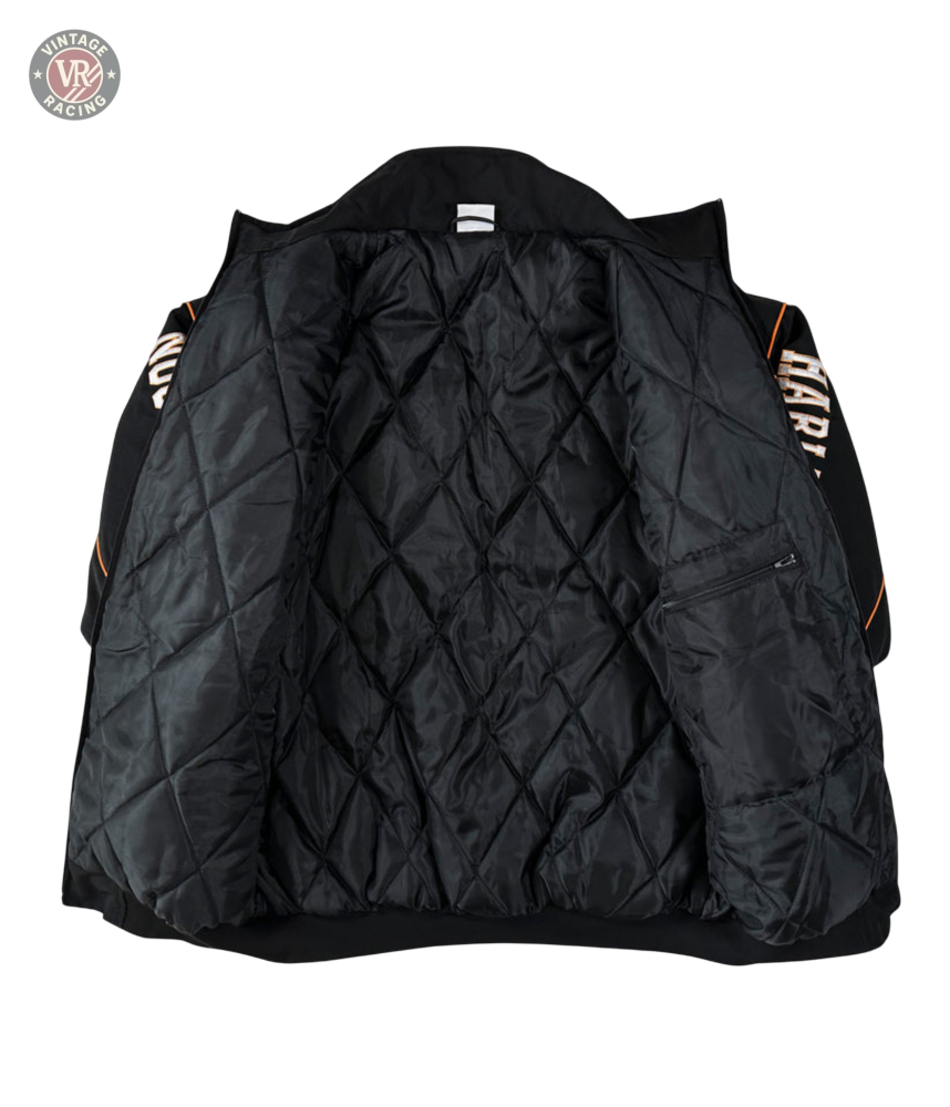 The Vintage Harley Davidson Jacket, shown open, reveals a diamond-patterned lining and a small left zip pocket. Its black quilted sleeves feature bold orange and white text, reminiscent of classic retro motorcycle jacket style.